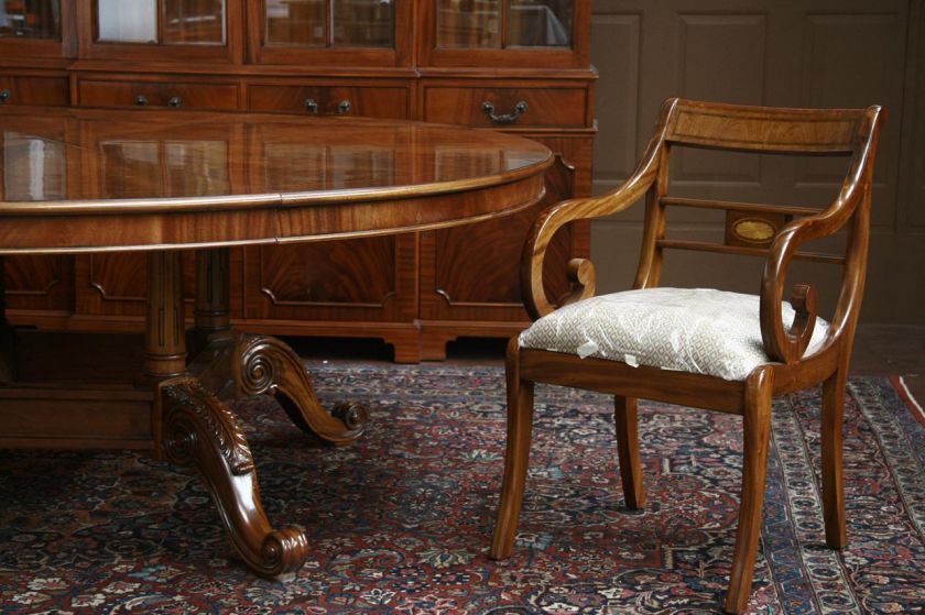 Large round mahogany table shown with 10 Chippendale chairs.